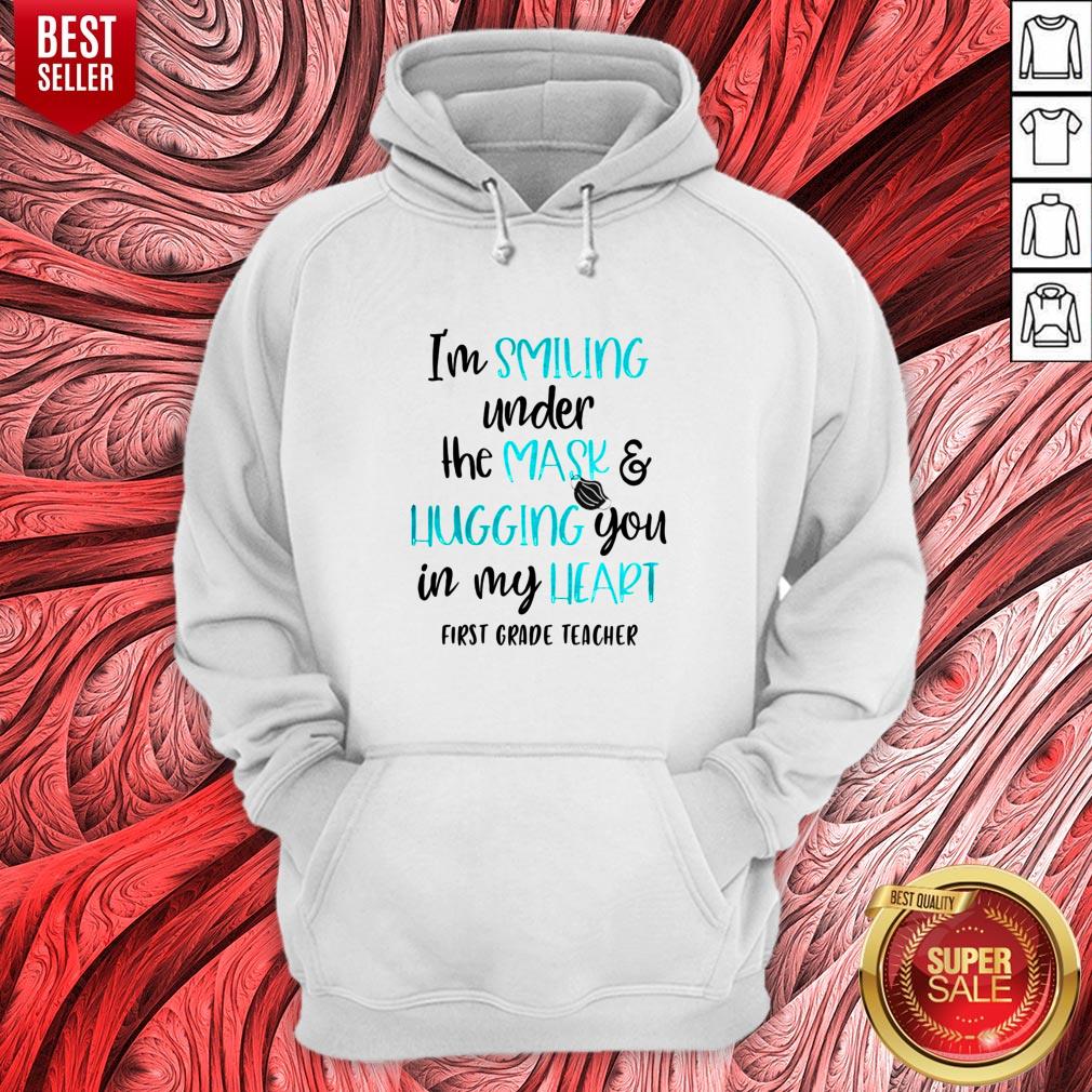 top-im-smiling-under-the-mask-and-liugging-you-in-my-heart-first-grade-teacher-hoodie.jpg