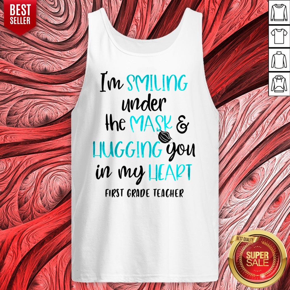 top-im-smiling-under-the-mask-and-liugging-you-in-my-heart-first-grade-teacher-tank-top.jpg
